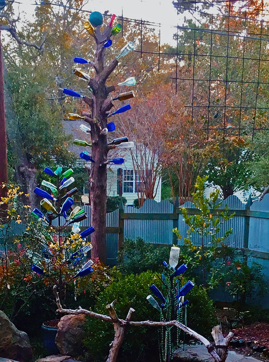 The finished bottle tree is over 17 feet tall and is accented by two smaller bottle trees nearby