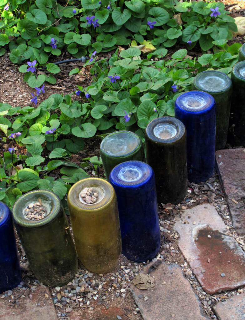 Glass bottle used as flowerbed edging