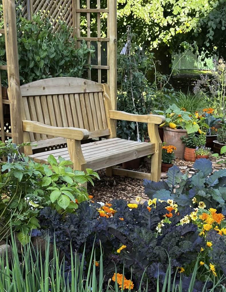 Kitchen garden with wooden arbor and bench