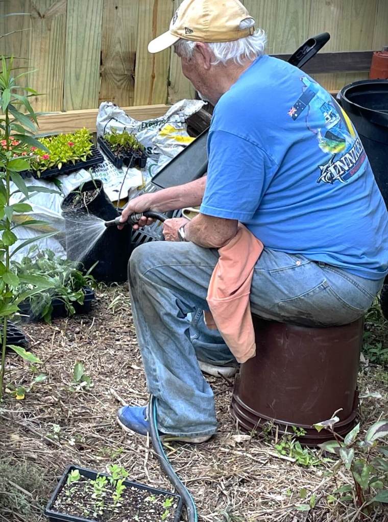 Gardener sitting on an upturned bucket