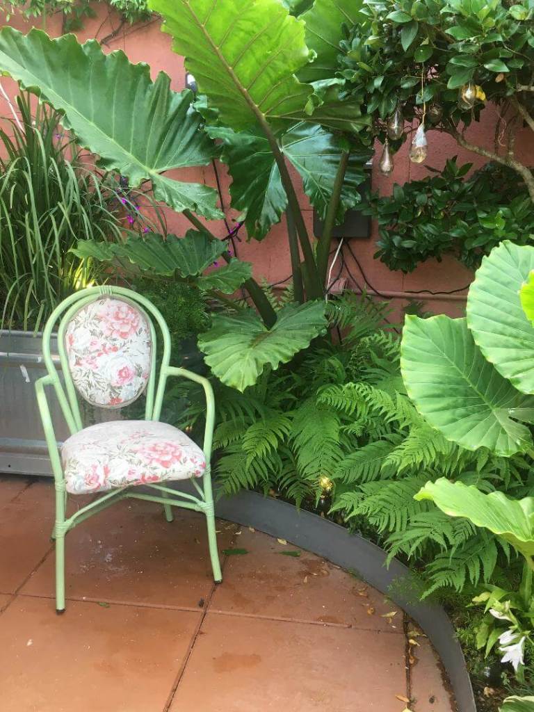 Dainty green chair with weather resistant cushions