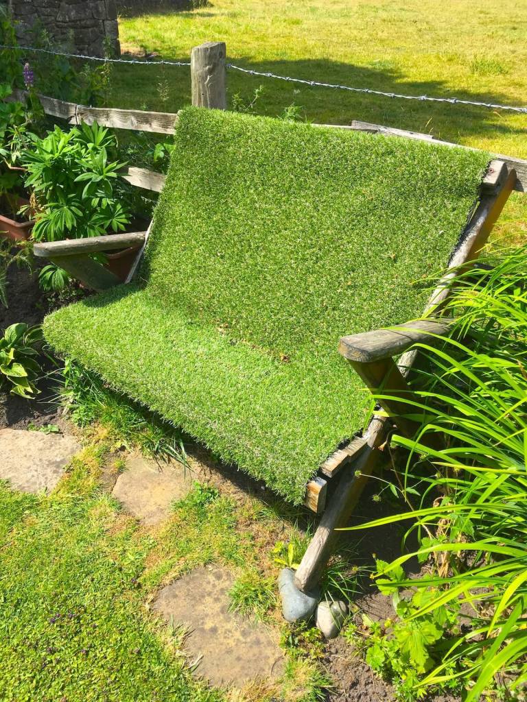 Wooden seat covered by synthetic grass
