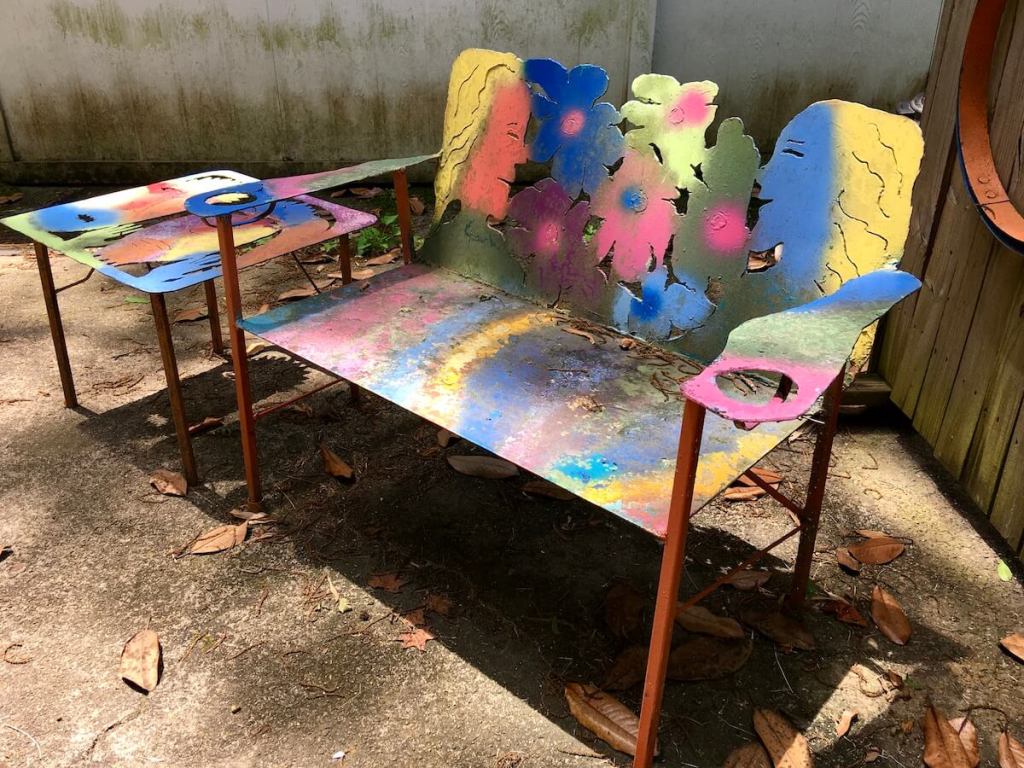 Colourful bench with his and her cut out design by local craftsman