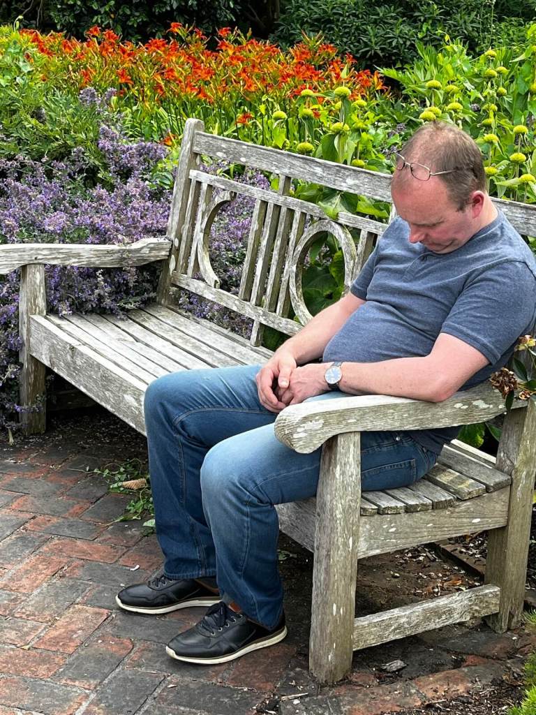 Man sleeping on a garden bench