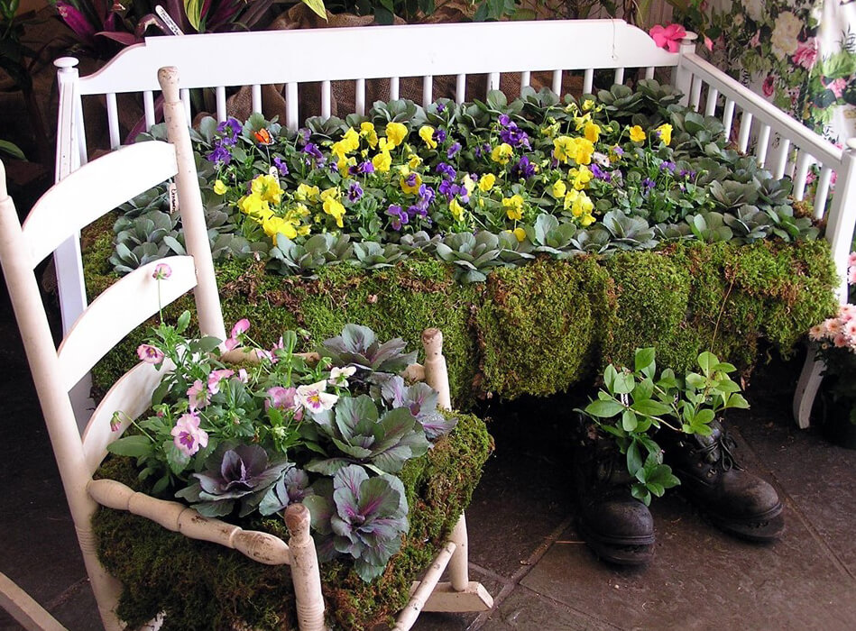 Seating lushly planted with pansies and cabbages