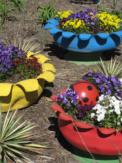 Tire planters in bold colors in Norfolk zoo children's garden